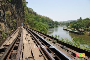 Visit Krasae cave and wooden railway bridge on a tour from Bangkok to Kanchanaburi. The bridge was constructed on the slope of a steep cliff.