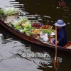 A farmer selling local produce at Damnoen Saduak floating market