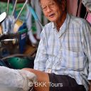 A tricycle rider taking a break at the Railway market in Samut Songkram. See it on our railway market tour from Bangkok.