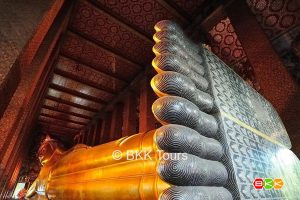 Visit Wat Pho on a Bangkok tour. Highlight of the temple is the Reclining Buddha with intricate mother of pearl decorations on the soles of the feet.